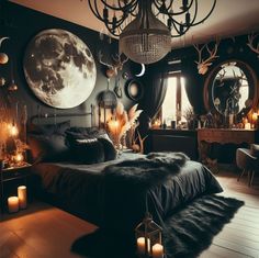 a bedroom decorated in black and white with deer antlers on the wall, candles lit up