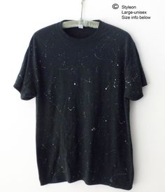 NEW Hand painted white and gray paint splatters on a black tee shirt, inspired by shooting stars. The manufacture of the original Tee shirt is JERZEES, 50% cotton/50% Polyester.  SIZE LARGE Unisex(Men's):   Approx. dimensions according to Jerzees are as follows: Width across the chest  is approx. 22inches, and  Length  is approx. 30 inches. More T-Shirts: https://www.etsy.com/shop/Styleon I try is get the colors as close to actual. Please note every computer monitor is different. Washing Instructions:  This tee has been washed since it was painted and is ready to wear!  Next time, turn inside out and wash in cold water, gentle cycle, then tumble dry low.  Do not iron. Relaxed Fit Paint Splatter T-shirt With Crew Neck, Black Cotton T-shirt With Paint Splatter, Bleached Black T-shirt For Streetwear, Black Graphic Tee With Paint Splatter, Black Crew Neck T-shirt With Paint Splatter, Black Paint Splatter Crew Neck Top, Relaxed Fit Cotton T-shirt With Paint Splatter, Casual Black Top With Paint Splatter, Grunge Style Star Print T-shirt For Summer