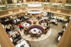 an overhead view of a restaurant with people eating and drinking at the tables in it