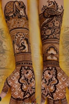 two hands with henna designs on them