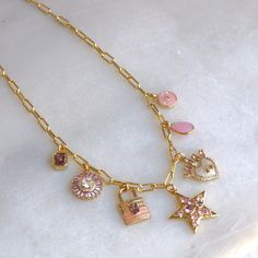 Pink Multi Charm Necklace Our multi charm necklace is the perfect way to express your jewelry style! Created on a 14kt gold filled mini paperclip chain and a variety of 7 different charms, this necklace will make a statement! •Gold plated charms •Thick paperclip chain•24kt gold plated -lead, nickel & cadmium free•Heavy plating, tarnish resistant, water friendly Everyday Pink Charm Necklace, Gem Necklace, Jewelry Style, 24kt Gold, Dainty Necklace, Personalized Necklace, 14kt Gold, Paper Clip, Ring Necklace