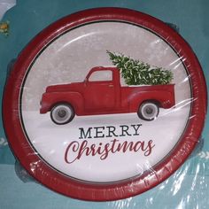 a red truck with a christmas tree on the back and merry christmas written on it