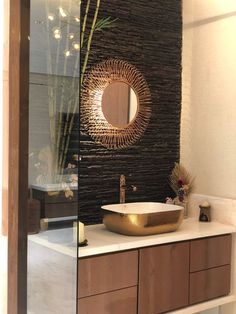 a bathroom with a sink, mirror and bamboo plant