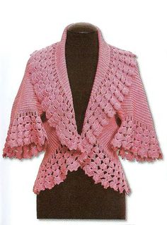 a pink crocheted jacket on top of a mannequin