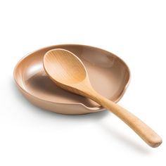 two wooden spoons sitting on top of each other in front of a white background