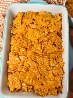 a casserole dish filled with cheese and tortilla chips