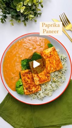 a bowl filled with rice, broccoli and tofu on top of a green napkin