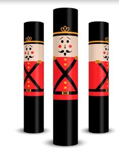 three black and red cylinder shaped candles with an image of a nutcracker in the middle