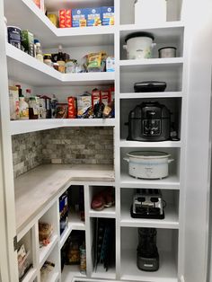 an organized pantry with white shelving and lots of food