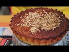 a chocolate pie with sprinkles sitting on top of a cake tin plate