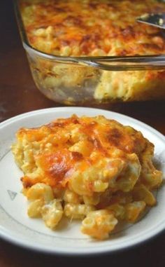 a casserole dish on a plate with a serving utensil next to it