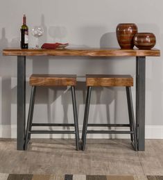 two wooden stools sitting under a table