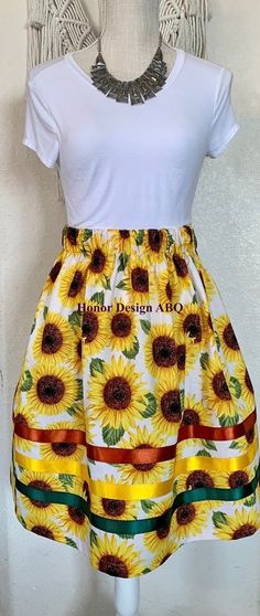 Traditional ribbon skirt in sunflower floral floral print.  Finished with elevated details such as yellow, green and rust satin ribbon, lovingly made by hand. A paper bag waist hugs the body, while also being comfortable to wear. See our sizing details below to find your perfect size.  Ready to ship! A long time symbol femininity, sisterhood and solidarity, used in ceremony and everyday, every skirt tells a story written by the woman who wears it. Perfect for every season, dressed up or down. Sa Sunflower Ribbon Skirt, Time Symbol, Paper Bag Design, Ribbon Skirt, Ribbon Skirts, Sunflower Print, Satin Ribbon, Design Process, Paper Bag