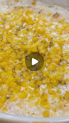 a white bowl filled with corn on top of a table