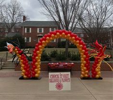 an arch made out of balloons in front of a building