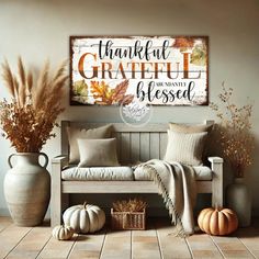 a wooden bench sitting next to two vases filled with flowers and pumpkins in front of a sign that says, thank grateful