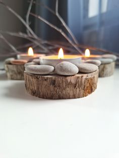 some rocks and candles are sitting on a table