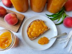 two pieces of bread on a plate with peach jam