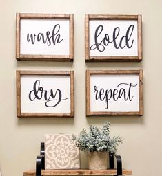 three wooden signs hanging on the wall above a shelf with plants and potted plant