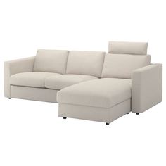 a beige sectional couch sitting on top of a white floor