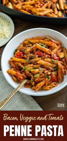 pasta with vegetables and tomatoes in a white bowl on a wooden table next to other dishes