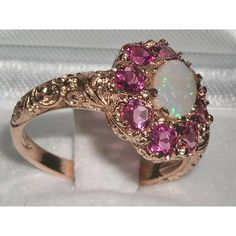 *This flower ring is made from 585 14K Rose Gold with Genuine Natural Semi-precious Opal & Pink Tourmalines.Like all my jewelry pieces, this ring is made in my own workshop. PLEASE MAKE SURE YOU STATE THE FINGER SIZE YOU REQUIRE WITH YOUR PAYMENT AND ALSO INCLUDE YOUR TELEPHONE NUMBER FOR DELIVERY COURIER.A beautiful Opal & Pink Tourmaline Ring set with a center 7x5mm (0.28"x0.20") Opal & eight 3.25mm (0.13" inches) vibrant Pink Tourmalines in a stylish Victorian Style cluster settin Exquisite Pink Round Rings, Pink Oval Multi-stone Ruby Ring, Fine Jewelry Pink Multi-stone Jewelry, Exquisite Pink Jewelry With Halo Setting, Pink Ruby Rings With Multi-stone Detail, Elegant Pink Cluster Ring In 14k Gold, Victorian Wedding Jewelry With Gemstone Accents, Elegant Pink Multi-stone Rings, Pink Opal Ring Fine Jewelry