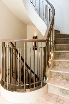 a staircase with metal handrails and marble steps