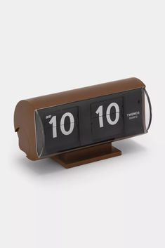 an alarm clock on a stand with the numbers ten and ten in it's display