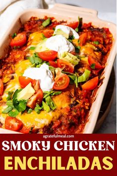 an enchilada casserole with sour cream on top and the words smoky chicken enchiladas above it