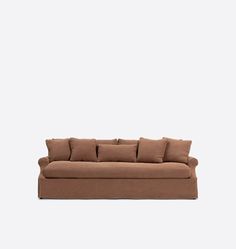 a brown couch sitting on top of a white wall