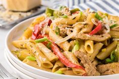 a white bowl filled with pasta and meat