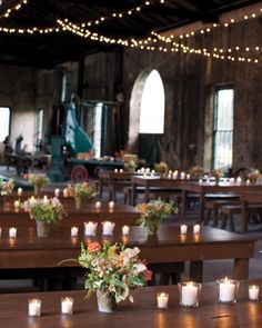 the tables are set with candles and flowers