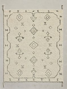 a white rug with black and grey designs on it