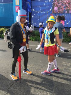 two people dressed in costumes standing next to each other