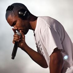 a man with headphones on singing into a microphone