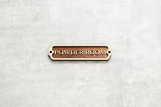 a sign that says powder room on the side of a building with no doors or windows