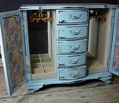 an old blue dresser with many drawers