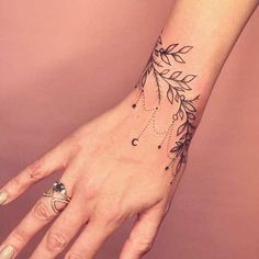 a woman's hand with a tattoo on it