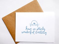 a card with the words have an otterly wonderful birthday written on it and a seal in blue ink