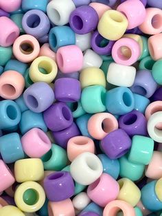 there are many different colored beads in this pile, and they look like they could be made from clay