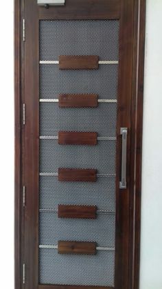 a wooden door with some metal bars on the front and side panels in different sizes