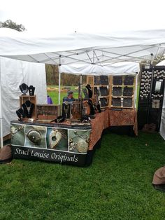 an assortment of jewelry on display under a tent