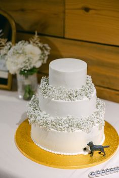 a three tiered white wedding cake on a table