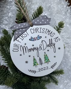 a personalized ornament hanging from a christmas tree