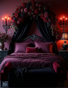 a bed with flowers and candles on the headboard in front of a red wall