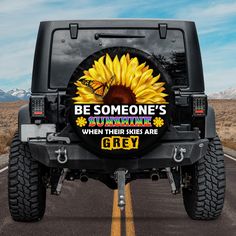 a black jeep with sunflowers on the back and be someone's sunshine behind it