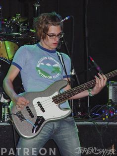 a young man is playing an electric guitar