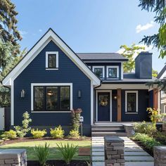 a blue house with steps leading up to the front door