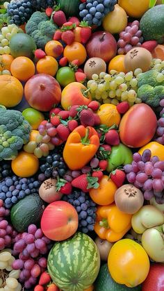 many different types of fruits and vegetables are grouped together to form a large pile on top of each other