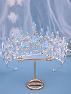 a tiara is displayed on a gold stand